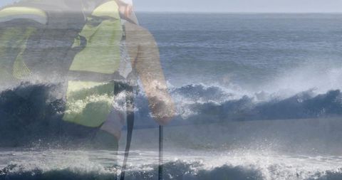 Female paddler cutting through ocean surf wearing fluorescent yellow life jacket