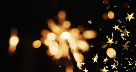 Bright Sparkler and Floating Stars on Black Background - Download Free Stock Images Pikwizard.com