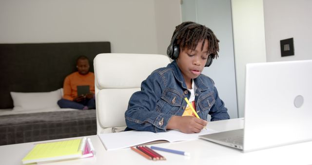 Young Student Doing Homework on Laptop with Assistance from Parent - Download Free Stock Images Pikwizard.com