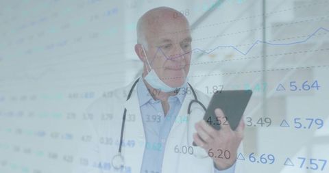 Doctor Analyzing Data on Tablet in Medical Hallway