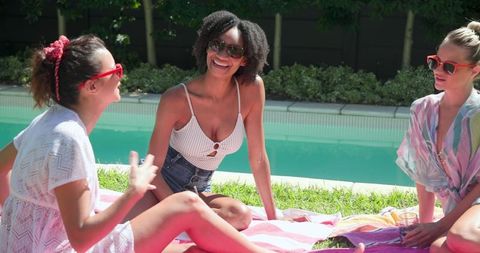 Diverse Group of Female Friends Relaxing by Pool
