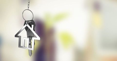 House Shaped Keychain Suspended in Air with Blurred Background