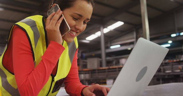 Female Industrial Worker Using Laptop and Talking on Phone in Factory - Download Free Stock Images Pikwizard.com