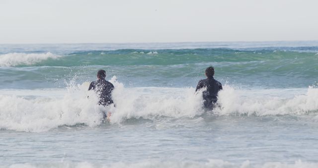 Two Men Surfing in the Ocean on a Bright Day - Download Free Stock Images Pikwizard.com