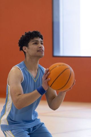 Focused Basketball Player Preparing Free Throw Indoors
