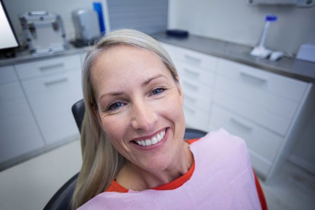 Beautiful female patient sitting on dentist chair at dental clinic