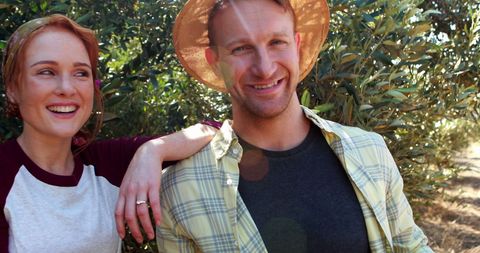 Joyful Couple Enjoying Sunny Farm Adventure in Nature