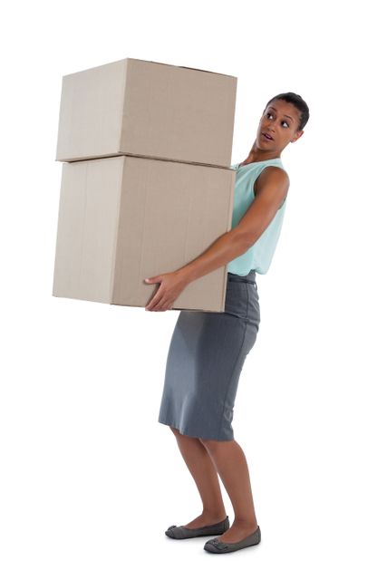Businesswoman carrying heavy boxes against white background