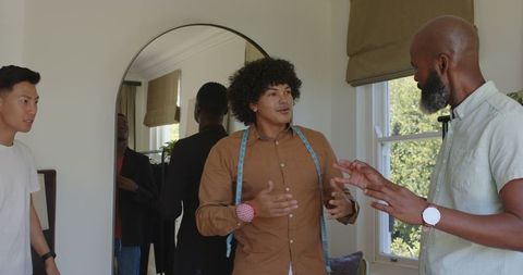 Friends preparing suits together for wedding celebration