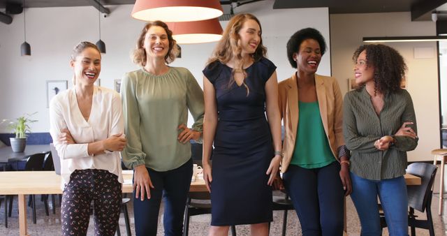 Diverse Group of Women Laughing in Modern Office Environment - Download Free Stock Images Pikwizard.com