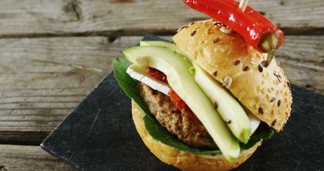 Gourmet Burger with Avocado and Chili Pepper Garnish - Download Free Stock Images Pikwizard.com