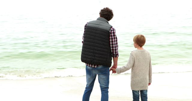 Father and Son Holding Hands While Strolling Along Beach - Download Free Stock Images Pikwizard.com