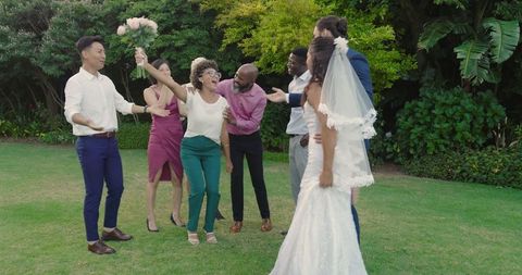 Bride and Groom Celebrating with Friends at Outdoor Wedding