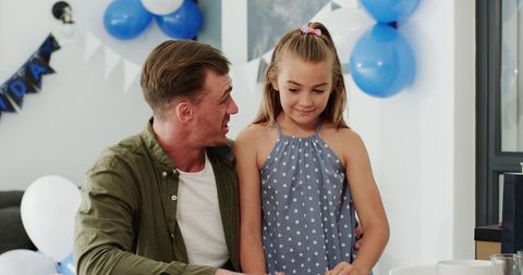 Father and Daughter at Birthday Celebration With Blue Theme
