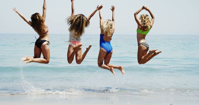 Group of Happy Women Jumping in Shallow Ocean Water - Download Free Stock Images Pikwizard.com