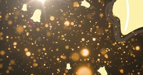 Glowing golden bokeh with floating bell icons for festive holiday background