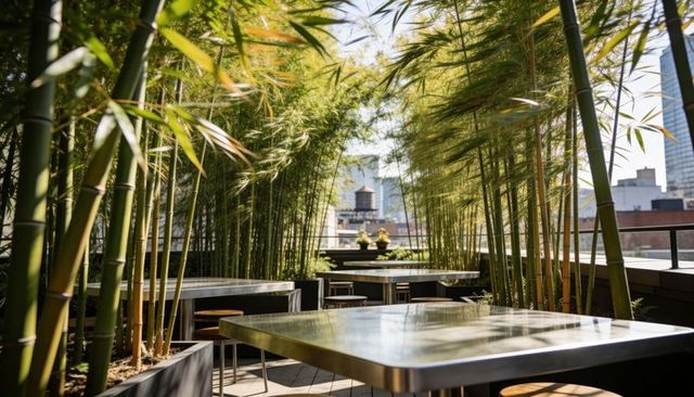Bamboo corridor framing rooftop terrace with metal tables, dappled sunlight, urban skyline