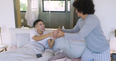 Cheerful Morning with Coffee Among Friends in Cozy Bedroom