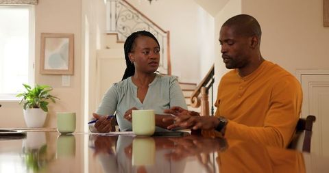 Couple Managing Finances Together at Home Office