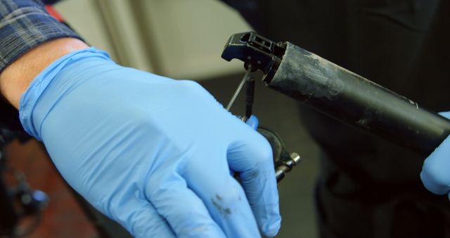 Mechanic Wearing Blue Gloves Repairing Bicycle Seat Post - Download Free Stock Images Pikwizard.com