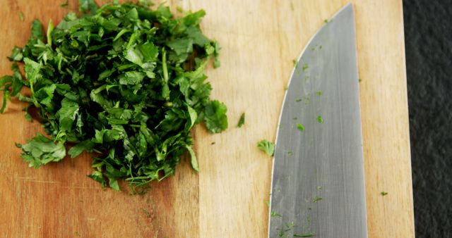 Chopped Fresh Cilantro with Chef's Knife on Wooden Cutting Board - Download Free Stock Images Pikwizard.com