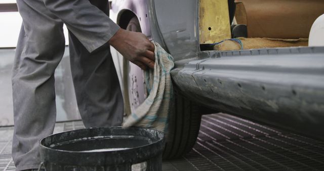 Mechanic Cleaning Car After Repair in Garage - Download Free Stock Images Pikwizard.com