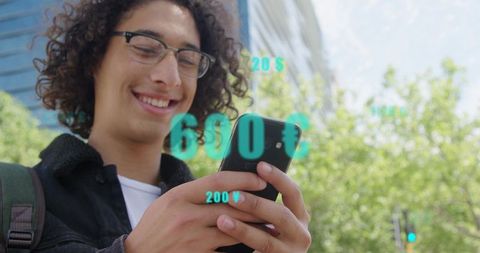 Smiling young man using smartphone with ar currency overlays in mobile banking and fintech