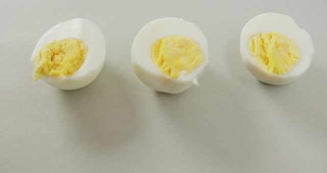 Three Halved Boiled Eggs on Light Background - Download Free Stock Images Pikwizard.com