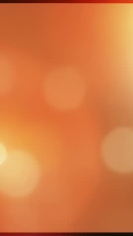 Vertical glowing orange bokeh background animation for mobile video and social stories