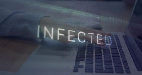 Typing hand over laptop showing INFECTED warning with glitch for cybersecurity visuals