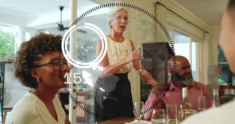 Senior woman giving heartfelt toast at home dinner party on patio with friends and wine
