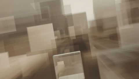 Floating transparent display case creating motion-blurred geometric gallery composition