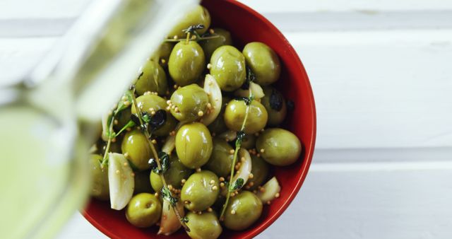 Green Olives in Red Bowl with Herb Seasoning and Garlic Cloves - Download Free Stock Images Pikwizard.com