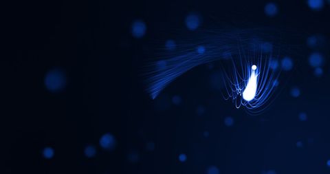 Glowing blue light streaks on dark background