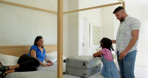 Family Preparing for Vacation with Suitcase on Bed, Indoor Setting