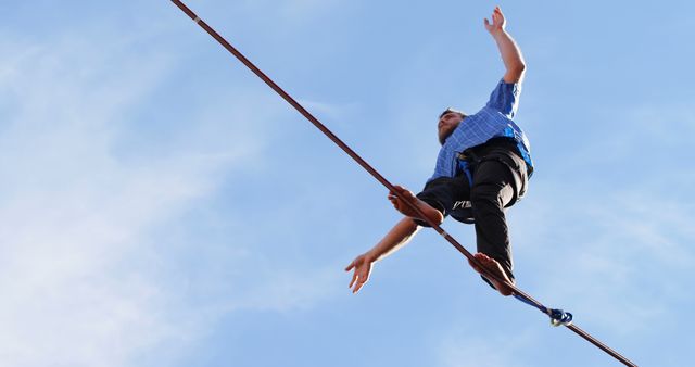 Daredevil Walking Tightrope High Above Ground Against Clear Blue Sky - Download Free Stock Images Pikwizard.com