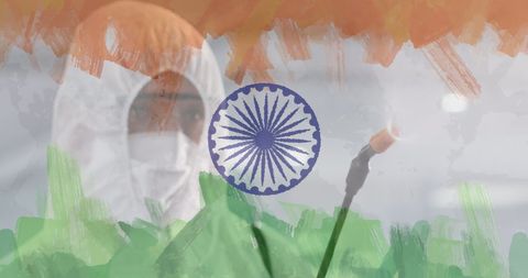 Worker in ppe suit disinfecting near indian flag symbol
