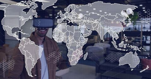 Man Wearing VR Headset Interacting with Digital World Map Overlay in Modern Office