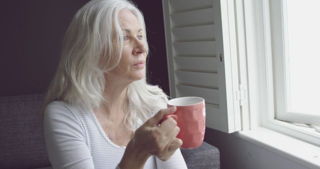 Elderly Woman Relaxing With Coffee By Window - Download Free Stock Images Pikwizard.com