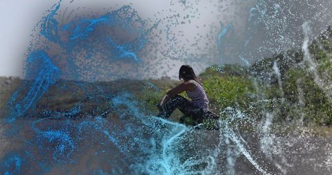 Woman contemplating nature with dynamic particle art
