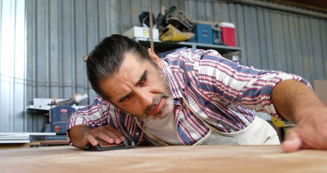 Focused Carpenter Sanding Wood in Workshop - Download Free Stock Images Pikwizard.com