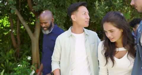 Friends Conversing Outdoors in Lush Garden Celebration