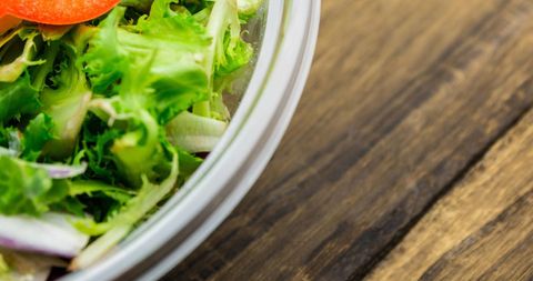 Close-Up of Fresh Vegetable Salad in Glass Bowl on Rustic Table - Download Free Stock Images Pikwizard.com