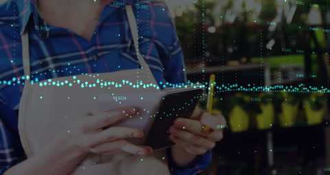 Businesswoman Using Digital Payment Terminal with Overlayed Financial Graphs