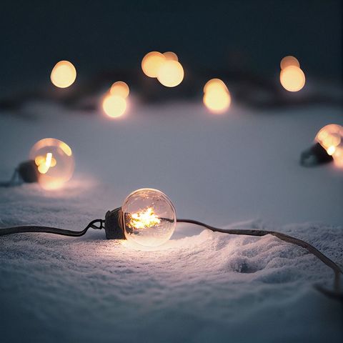 String Lights Glow in Snowy Ground with Warm Ambiance