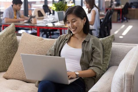 Young professional collaborating in modern office lounge