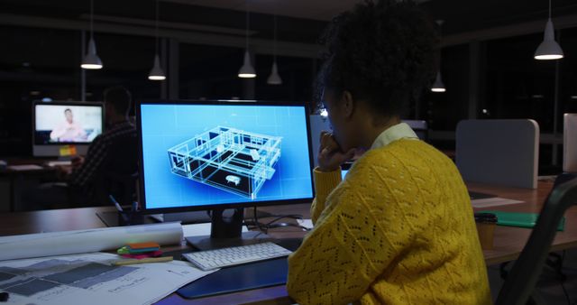 Woman concentrates on a 3D house design on her computer screen in a dimly lit office during the evening. Perfect for illustrating themes of innovation, dedication, and modern architectural practices. Useful for articles or content on architectural design, late-night project work, women in STEM, and creative professions.
