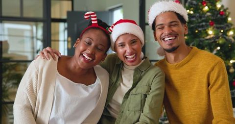 Diverse Friends Celebrating Christmas in Festive Office Setting