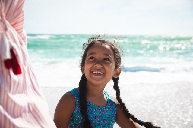 Smiling Girl with Pigtails Enjoying Beach Day - Download Free Stock Photos Pikwizard.com