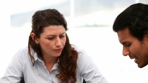 Colleagues Discussing Project in Modern Office Space